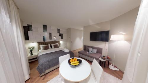 a bedroom with a bed and a table with bananas on it at VISIONAPARTMENTS Bellariastrasse - contactless check-in in Zürich