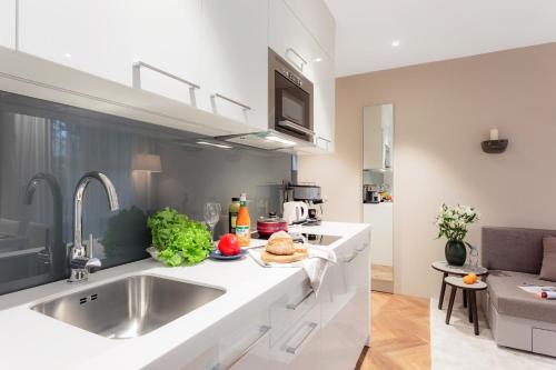 a kitchen with a sink and a counter top at VISIONAPARTMENTS Bellariastrasse - contactless check-in in Zürich