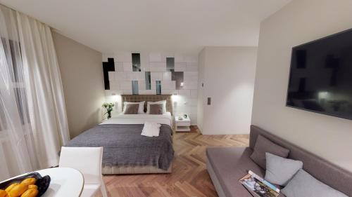 a bedroom with a bed and a living room at VISIONAPARTMENTS Bellariastrasse - contactless check-in in Zürich