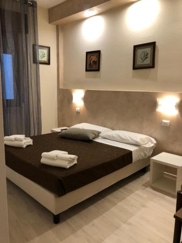 a bedroom with a bed with two towels on it at Hotel Arena in Verona