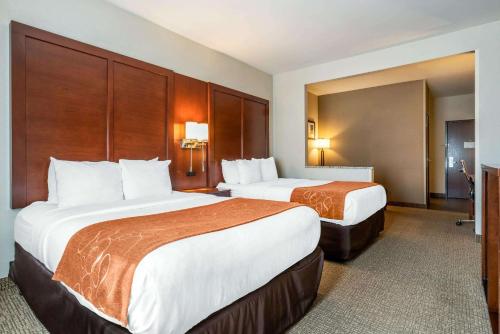 a hotel room with two beds and a television at Comfort Suites Yakima in Yakima