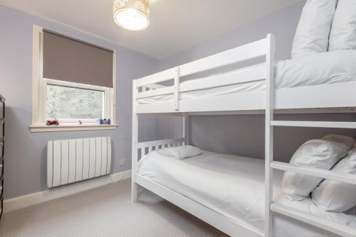 a bedroom with two bunk beds and a window at Marine Park - Perfect Elie Base - 1 min to Beach in Elie