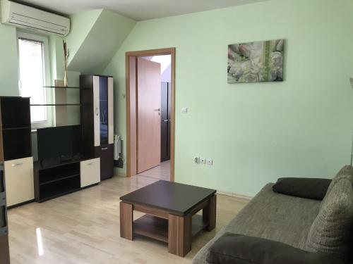 a living room with a couch and a coffee table at BLOCK 531 ApartHouse BLOCK 533 in Sofia