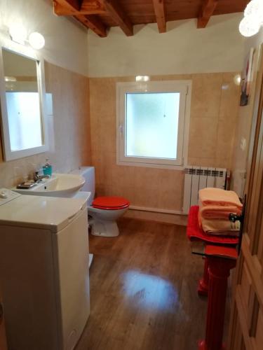 a bathroom with a sink and a toilet and a window at Los Castaños in Solana de ávila