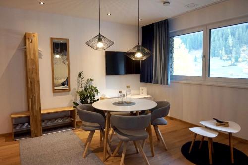 a dining room with a table and chairs at see.view apartment in See