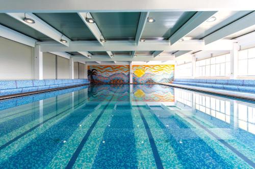 an empty swimming pool with a painting on the wall at Grad Sunca Resort in Trebinje