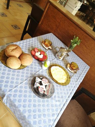 a table with plates of food on top at Tulip Hotel in Cairo