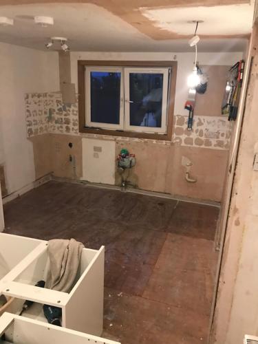 a living room under construction with a stone wall at “A Wee Pad in Dunfermline” in Dunfermline