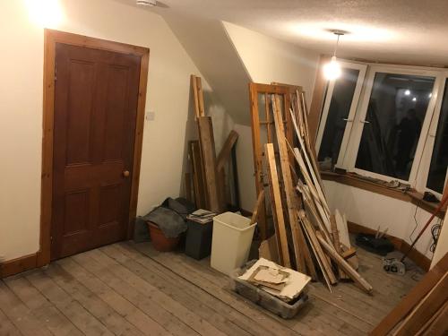 a room with a door and a bunch of wood at “A Wee Pad in Dunfermline” in Dunfermline