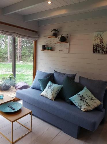 - un canapé bleu dans le salon dans l'établissement Valhalla puhkemaja Hiiumaal, à Hiiessaare