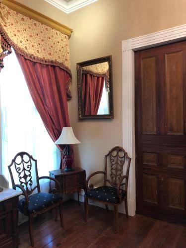 a room with two chairs and a table and a mirror at The Montgomery B&B in Starkville