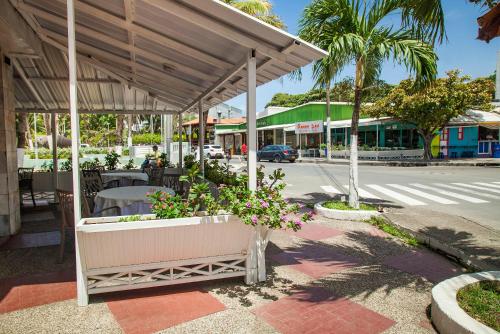 a pavilion with tables and flowers on a city street at Sol Caribe Sea Flower in San Andrés