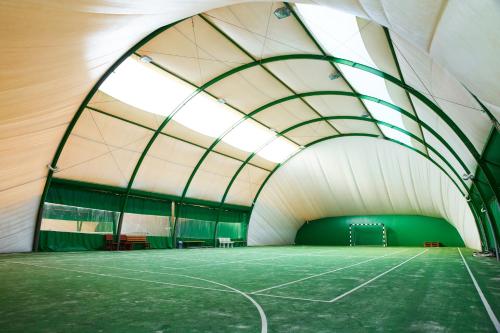 a tennis court inside of a tunnel at Ośrodek Ukazia in Orzechowo