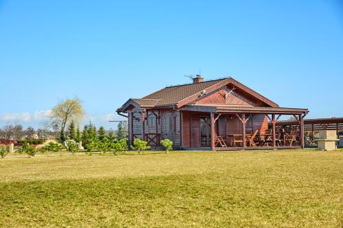 a house with a large yard in front of it at Ośrodek Ukazia in Orzechowo