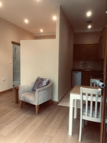 a living room with a chair and a table at Courtyard Studio in Armagh