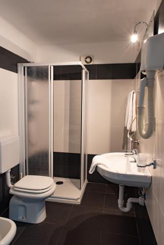 a bathroom with a shower and a toilet and a sink at Hotel Principe in Sanremo