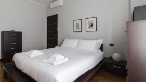 a bedroom with a white bed with two towels on it at Italianway - Antonia Pozzi 5 in Milan