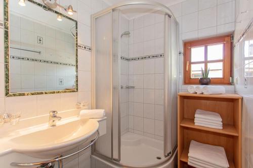 a bathroom with a shower and a sink at Blockhaus Ganschitter in Grossarl
