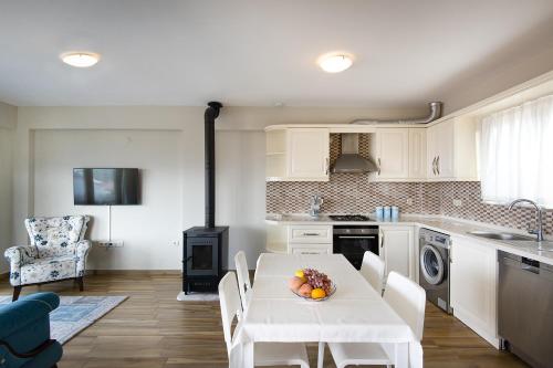 a kitchen with a table with a bowl of fruit on it at Bodrum sea view villa with access to private beach in Bogazici