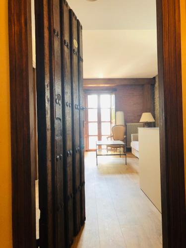 a hallway with a room with a door and a room with a table at Posada La Torre de La Quintana in Liendo