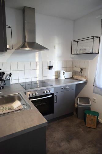 a kitchen with a sink and a stove top oven at Ferienwohnung Stöckel in Cuxhaven