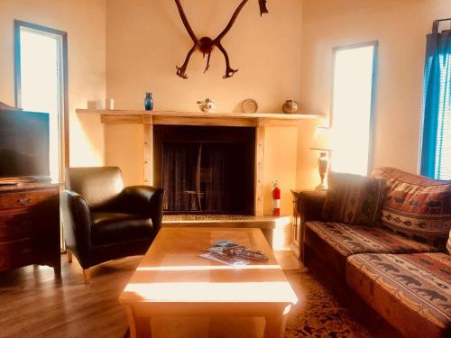 a living room with a couch and a fireplace at Driftwood Inn in Homer