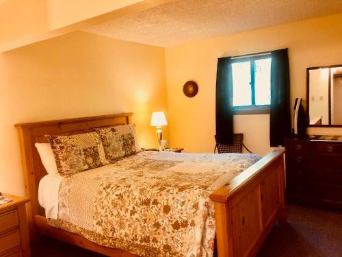 a bedroom with a bed and a window at Driftwood Inn in Homer