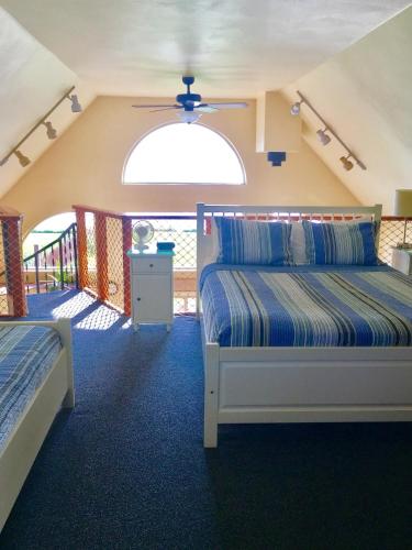 a bedroom with two beds and a balcony at Driftwood Inn in Homer
