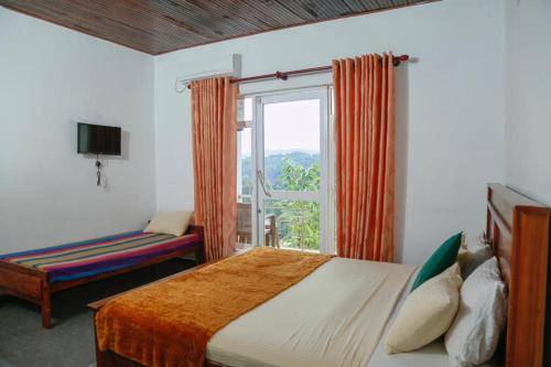 a hotel room with a bed and a window at Mount Palace in Kandy