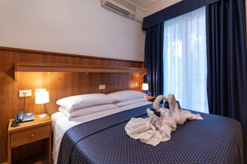 Postel nebo postele na pokoji v ubytování Hotel Mimosa