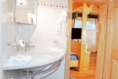 a bathroom with a sink and a mirror at Appartment Maurer in Oetz