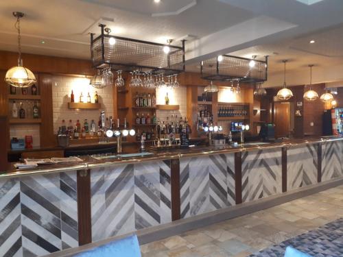 a bar at a restaurant with a checkered counter at The Grey Horse in Darlington