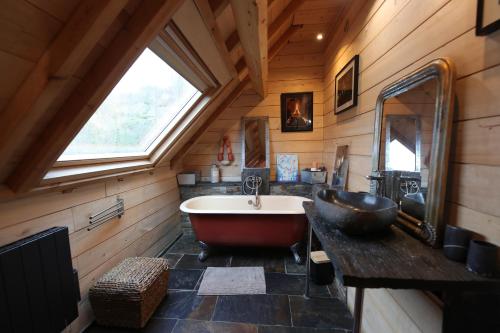 a bathroom with a large tub and a large window at Chalet Montagne in Saint-Pastous