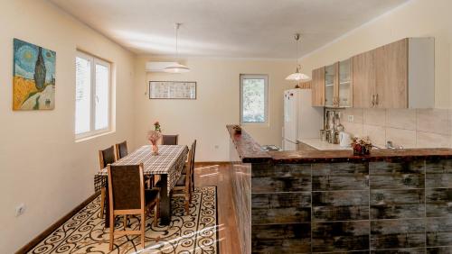 a kitchen with a table and a dining room at Villa Relax in Herceg-Novi
