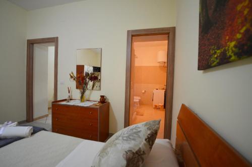 a bedroom with a bed and a dresser and a mirror at IL PARADISO DEGLI DEI 2 in Agerola