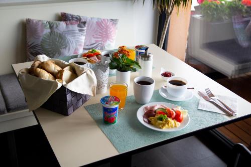 a table with a plate of food and a basket of bread at Penzion Na Svahu in Cheb