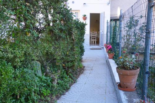 a sidewalk next to a fence with potted plants at IL PARADISO DEGLI DEI 2 in Agerola