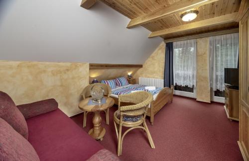 a living room with a couch and a table at Hotel Resort Martin & Kristyna in Špindlerův Mlýn