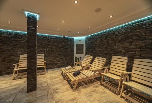 a group of chairs in a room with a brick wall at Hotel Resort Martin & Kristyna in Špindlerův Mlýn