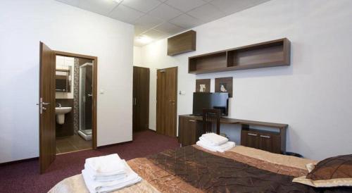 a hotel room with a bed and a bathroom at Garni Hotel Branč in Senica