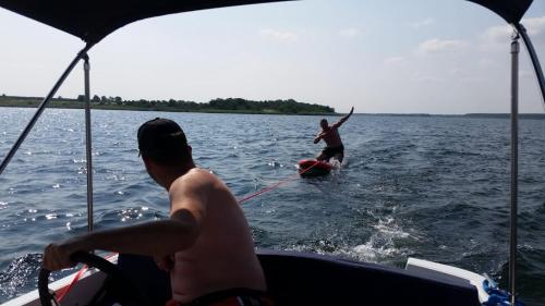 two people on a boat in the water at Hausboot Elandi in Bitterfeld