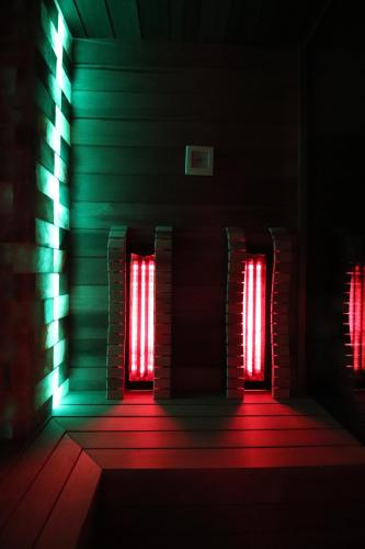 a dark room with red and green lights at Baobab Suites in Siófok