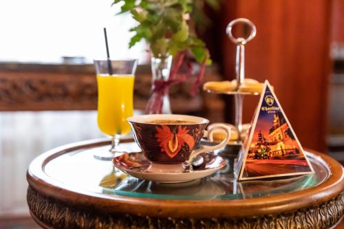 a table with a cup of coffee and a drink at Charlino Plaza in Ruse