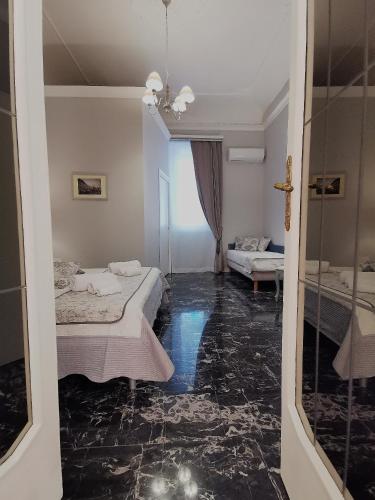 a room with two beds and a cross on the floor at Il galleone in Messina