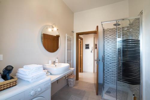 a white bathroom with a sink and a shower at Cozy Home in Monte Amiata in Abbadia San Salvatore