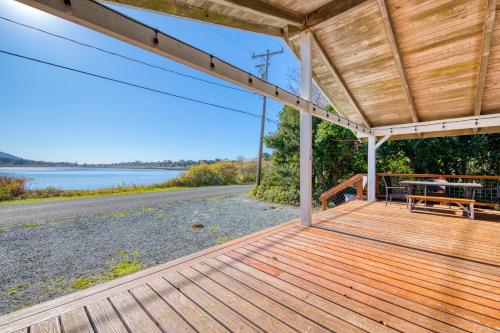 a wooden porch with a view of a lake at Ara Vista in Rockaway Beach