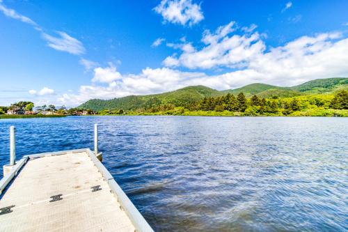 a dock on a lake with mountains in the background at Lake Lytle Lookout in Rockaway Beach