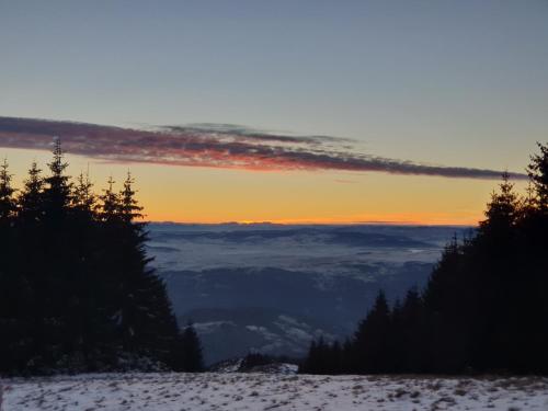 a view of the sunset from the top of a mountain at Home Belić Golija in Radaljica