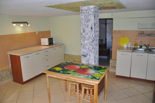 a kitchen with a small table and a counter top at Willa pod Brzozami in Niechorze