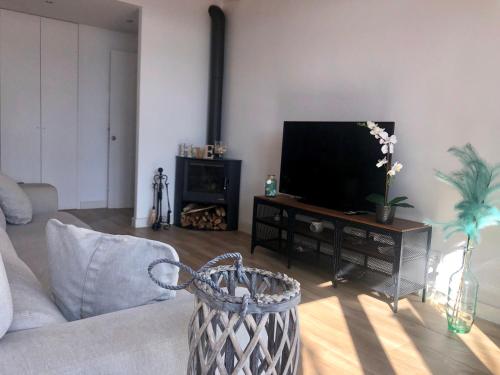 a living room with a couch and a flat screen tv at Vilamarlux III in Vilassar de Mar